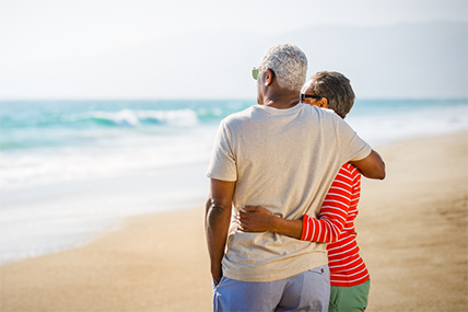 older couple hugging at the beach