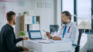primary care doctor is Explaining Diagnosis to a Young Male Patient