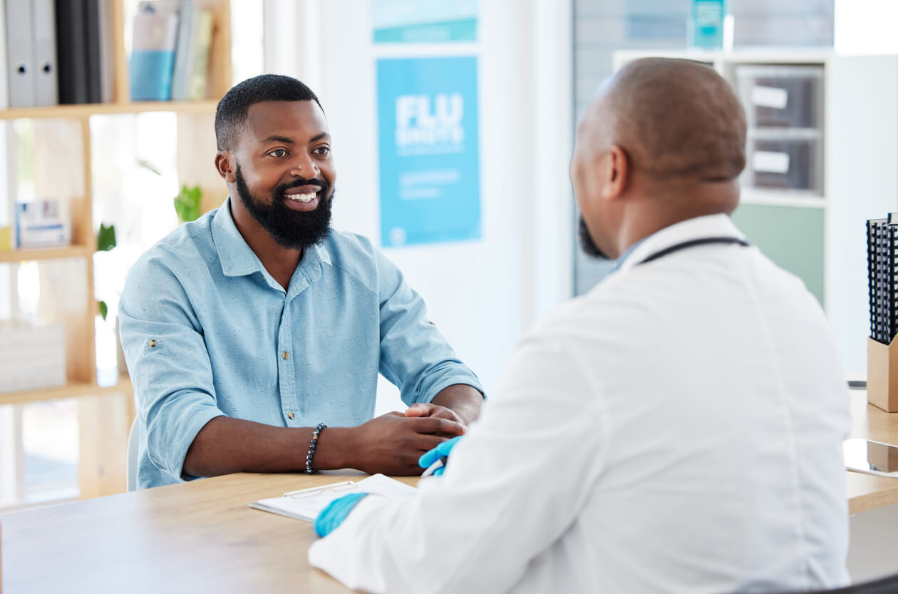 Young man getting a a DOT physical and talking to his family doctor