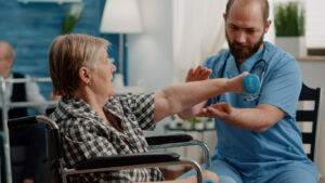 A patient with chronic pain is performing physical exercises using dumbbells as part of their chronic pain treatment.